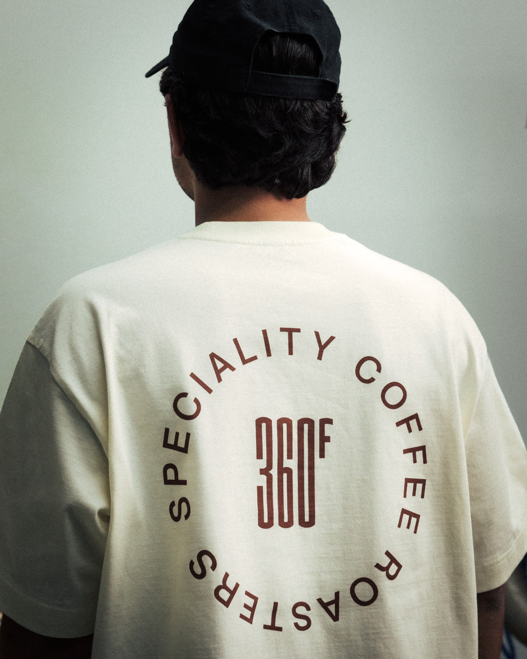 Person wearing a shirt with 'Specialty Coffee Roasters 360F' text on the back.